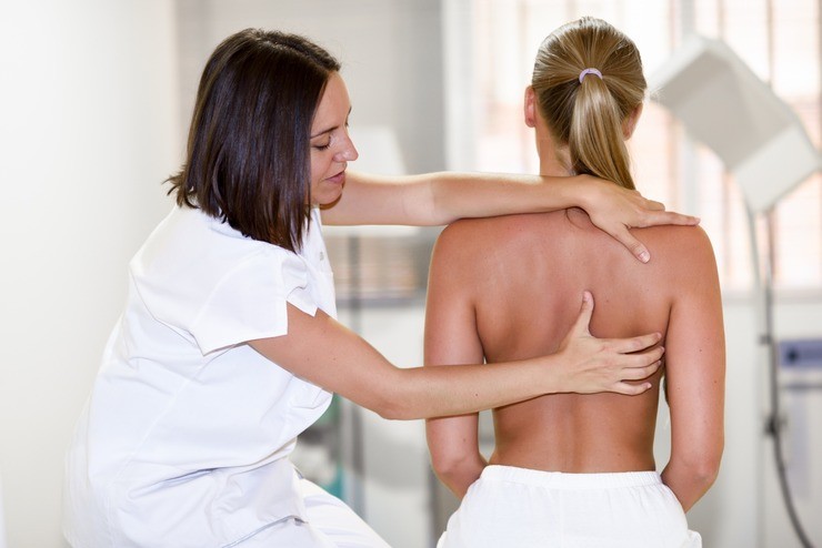 Therapist assessing a shoulder